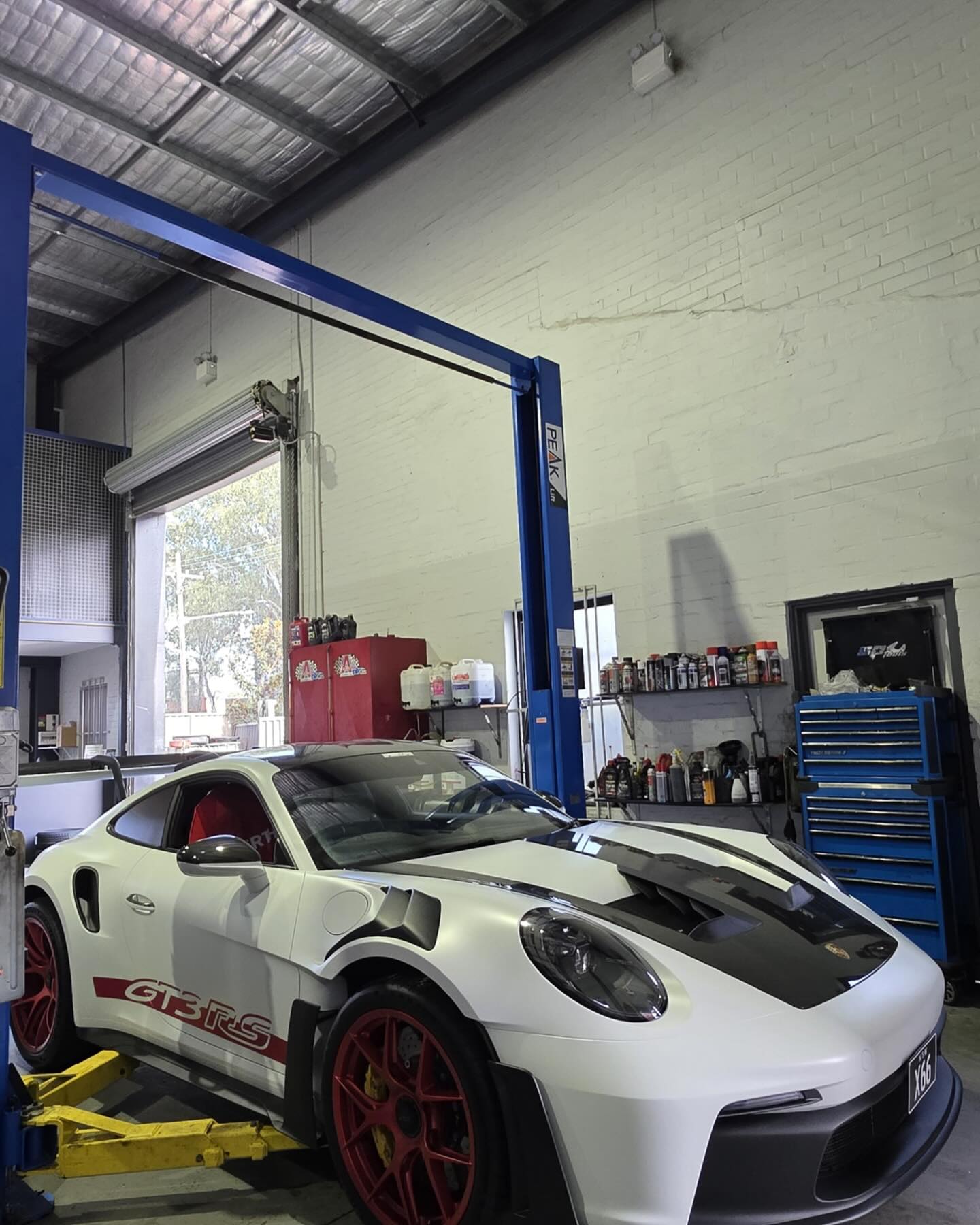 Luxury sedan on a hoist in the Service Haus workshop